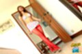 Standing with legs crossed adjusting skirt wearing red stockings high heels