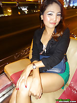 Seated in bar arms crossed over her bare thigh